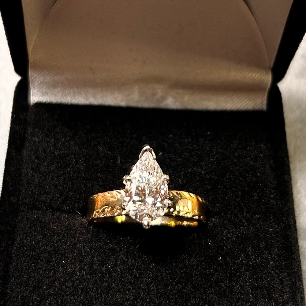 1.2kt lab created with certified papers pear diamond set in 14 kt gold .